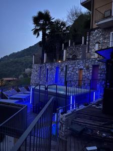 a pool with blue lights in front of a building at Fenil Del Santo in Tremosine Sul Garda