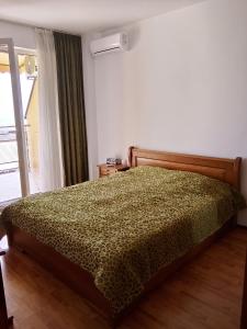 a bedroom with a bed in a room with a window at Alegria in Varna City +27 photos