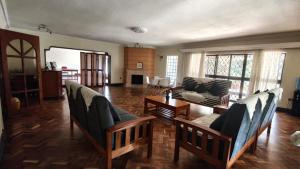 a living room with couches and a table at Ilemi Gardens in Nairobi