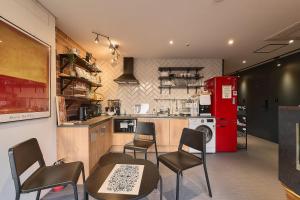 a kitchen with chairs and a red refrigerator at Artravel Myeongdong in Seoul +136 photos