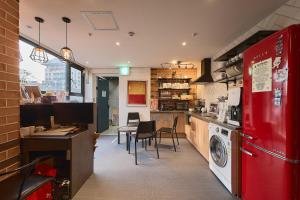 a kitchen with a red refrigerator and a washer at Artravel Myeongdong in Seoul