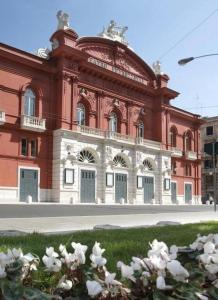 a red building with white flowers in front of it at Eleven Home in Bari +5 photos