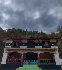 a building with red windows and a cloudy sky at Chug Ling Serene in Chug