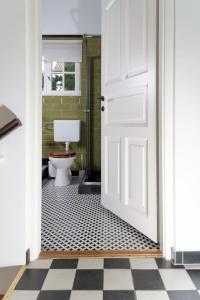an open door to a bathroom with a toilet at KIS CINKE Guesthouse in Tahitótfalu +13 photos