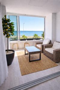 a living room with a view of the ocean at Mackenzie Beachfront Panorama in Larnaca +7 photos
