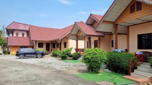 a car parked in front of a house at Sinsawat Resort in Uttaradit