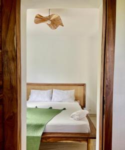 a bedroom with a bed with a bow on it at Le petit Relais 1 in Andilana