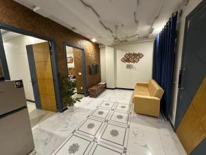 an office hallway with a door and a chair at Two Bed Appartment in Islamabad