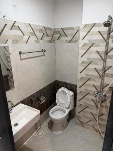 a bathroom with a toilet and a sink at Two Bed Appartment in Islamabad +16 photos