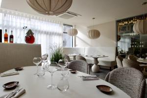 a table with wine glasses on it in a restaurant at Hostellerie Saint Germain in Saint-Germain-lès-Arlay
