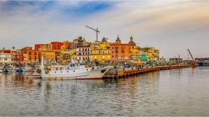 a group of boats docked in a harbor with buildings at Il Cas8tto in Pozzuoli