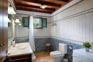 a bathroom with a toilet and a sink at Casa Crisana in Haría +33 photos
