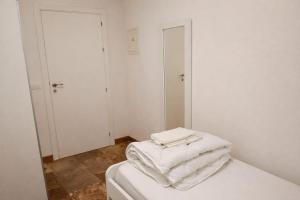 a room with a bed with white sheets and a mirror at Pórtico del Azahín in Cazalla de la Sierra +37 photos