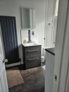 a bathroom with a sink and a toilet at The Old Bank bed & breakfast in Millport +22 photos