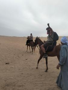 a group of people riding horses in the desert at Ancient Bakyard Guesthouse in Abū Şīr