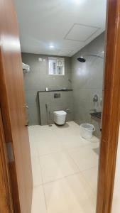a bathroom with a toilet and a bidet at Darling Grand SME in Vellore