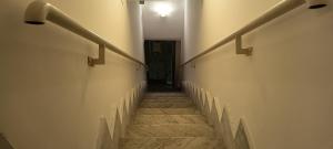 a hallway with stairs with a light at the top at Il Cas8tto in Pozzuoli +2 photos