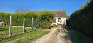 a dirt road in front of a house with a fence at The Private House in Paroy