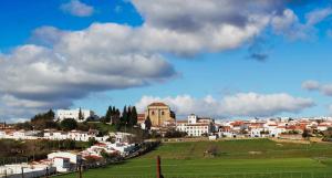 a group of buildings on a hill in a city at Pórtico del Azahín in Cazalla de la Sierra