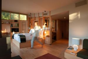 a person running in a bedroom with a bed at Les Échasses Golf & Surf Eco Lodge in Saubion