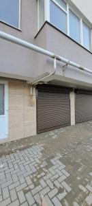 two garage doors on the side of a building at SkyHouse&PrivateGarage in Chişinău