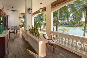 a porch with a large window and a view of the water at Anantara Hoi An Resort in Hoi An