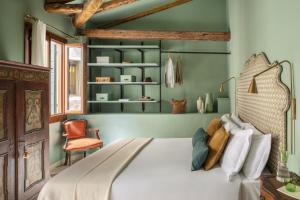 a bedroom with a white bed and green walls at Hotel Riva in Venice