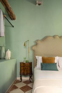 a bedroom with a bed and a side table at Hotel Riva in Venice +26 photos