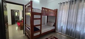 a bedroom with two bunk beds in a room at Brighton Hostel Stays in Sultan Bathery