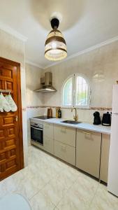 a kitchen with a sink and a stove top oven at Casa Verde 56 in Cumbre del Sol