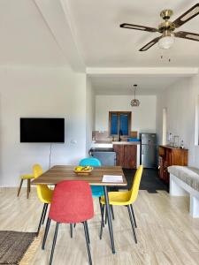 a dining room and living room with a table and chairs at Le petit Relais 1 in Andilana