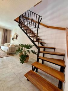 a spiral staircase in a living room with a bench at Casa Verde 56 in Cumbre del Sol
