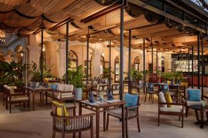 a restaurant with tables and chairs in a building at Anantara Hoi An Resort in Hoi An
