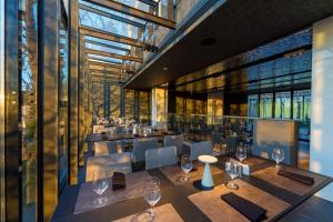 a restaurant with tables and chairs and windows at Hotel Privo in Târgu-Mureş +56 photos