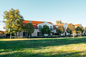a row of houses with trees in a park at Levendula Hotel in Algyő
