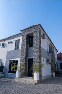 a building with two potted plants in front of it at Sanctum Suites in Abuja