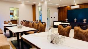 a restaurant with tables and chairs and a stage at Hotel Roop Cliff, Bhopal in Bhopal