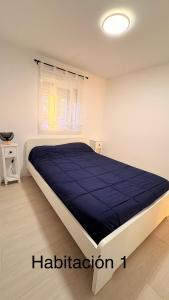 a bedroom with a large bed with a blue blanket at Las Colinas in Illana +39 photos