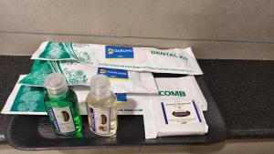 a black table with dental kit and two bottles of toothpaste at Darling Grand SME in Vellore