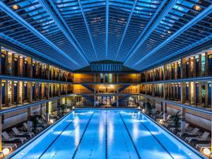 a swimming pool in a building with a ceiling at Molitor Hotel & Spa Paris - MGallery Collection in Paris