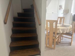 a staircase in a room with a table and a chair at Maison confort ombragé 2 chambres in Amélie-les-Bains-Palalda