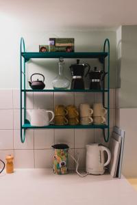 a kitchen with green shelves filled with pots and pans at Appartement de vacances Papillon Stilvoll wohnen im Herzen der historischen Altstadt von Porrentruy in Porrentruy