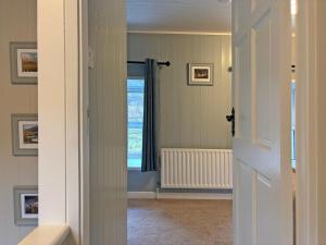 an open door to a room with a window at Cottage 496 - Leenane in Leenaun +21 photos
