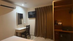 a hotel room with a desk and a television at My Hotel @ Sentral in Kuala Lumpur