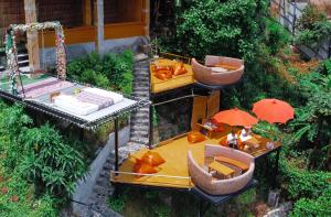 an overhead view of a patio with a table and chairs at The Cozy Beachfront Phuket in Patong Beach