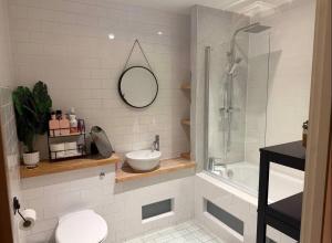 a bathroom with a toilet and a sink and a shower at Advent House Ancoats Hosted Apartment in Manchester