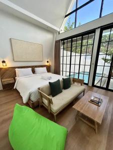 a large bedroom with a large bed and a couch at Gauri Vasanta Villa with Private Pool Yogyakarta in Yogyakarta +116 photos