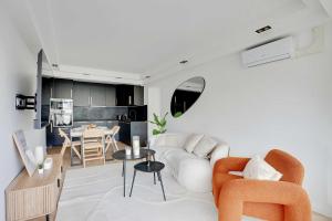 a living room with a white couch and a table at Charming Apt with AC & balcony in Suresnes +12 photos