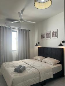 a bedroom with a bed with two pillows on it at Duchess Home Taman Colonial in Raub