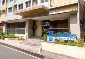 a building with a sign in front of a building at JL Suites by Hiverooms in Cebu City